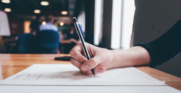 Image of woman drawing a wireframe and scribbling text on a table for Build Hello's content writing web page. Optimizing your website for search engines is a matter of getting landing pages and text indexed by search engines. You also want your text to speak to your audience. It makes sense to hire someone to write you an article every week. Spending a few thousand dollars on web content every month or two is a great way to get your website noticed!